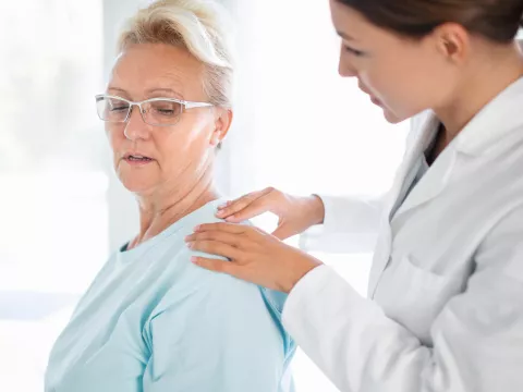 Woman Discussing Her Pain with Doctor