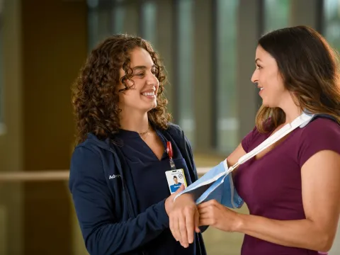 A female healthcare worker and female patient.