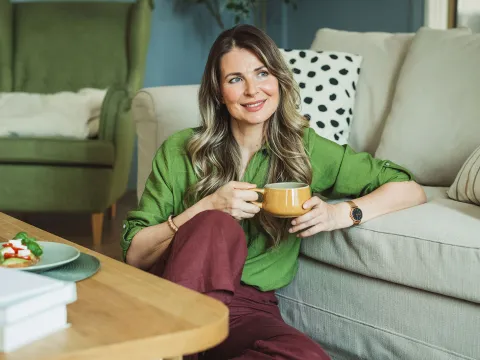 A middle-aged woman drinking coffee.
