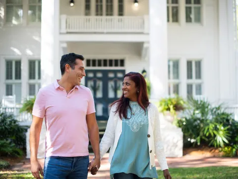 Happy Hispanic Couple walking together outdoors