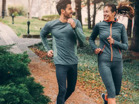 Two friends jogging in a park