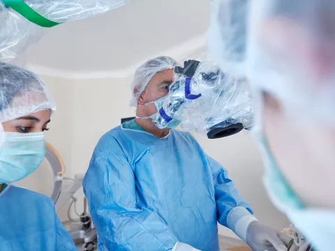 A doctor using a machine to assist in surgery