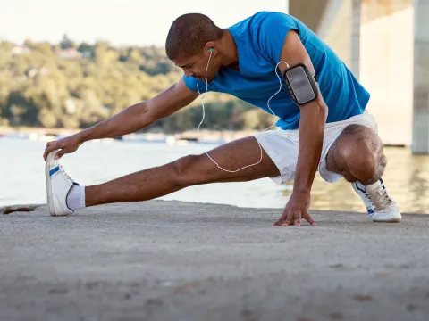 A man stretching after a run. 