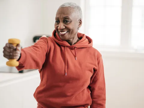 A mature woman exercising at home. 