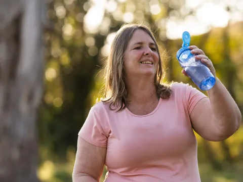 Overweight woman exercising outside