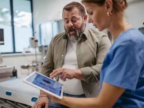 A male patient talks with a female doctor about his test results.