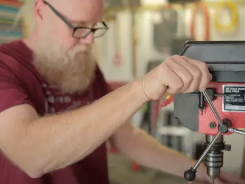Mat Germann operating a drill press.