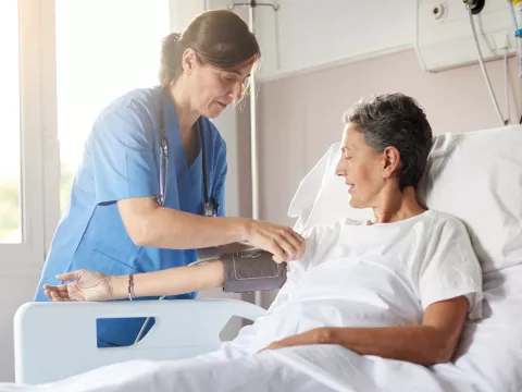 nurse and patient in hospital room