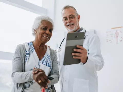 Senior woman patient talking with male doctor.