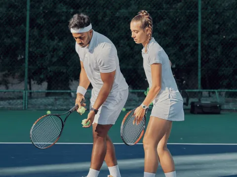 A man and woman playing tennis.