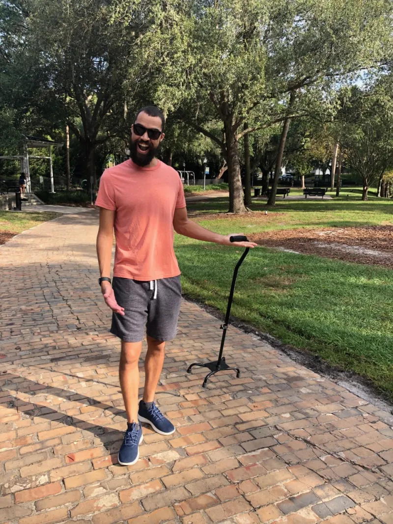 Brandon walking with his cane